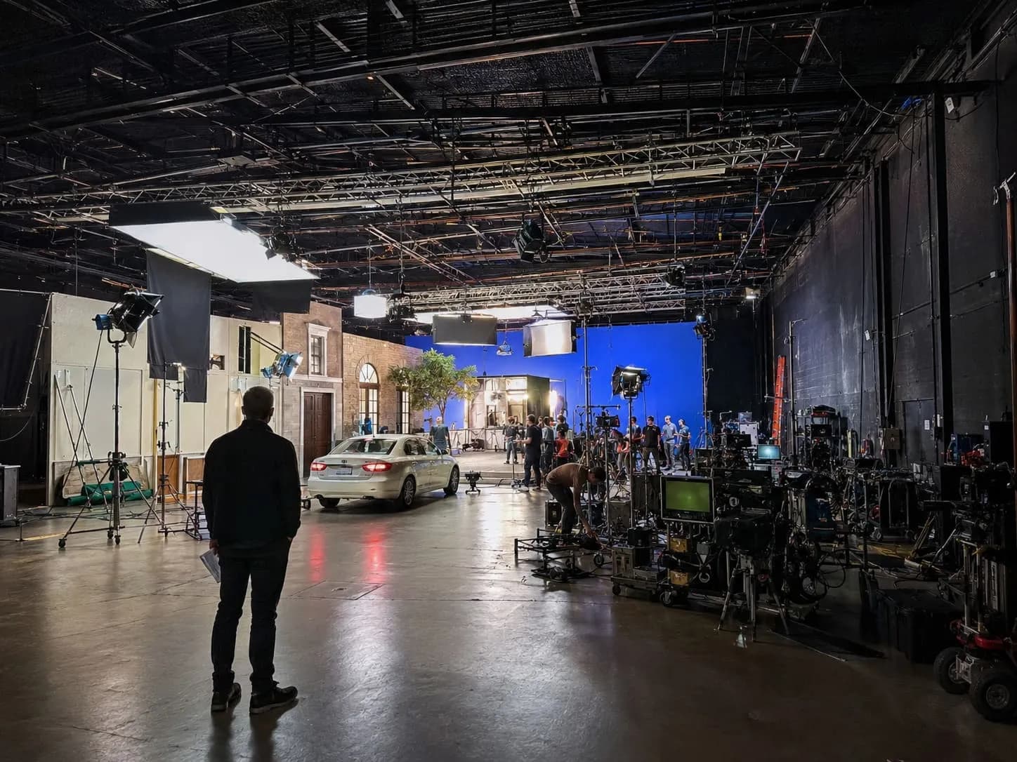 A photo showing a gaffer overlooking a film set