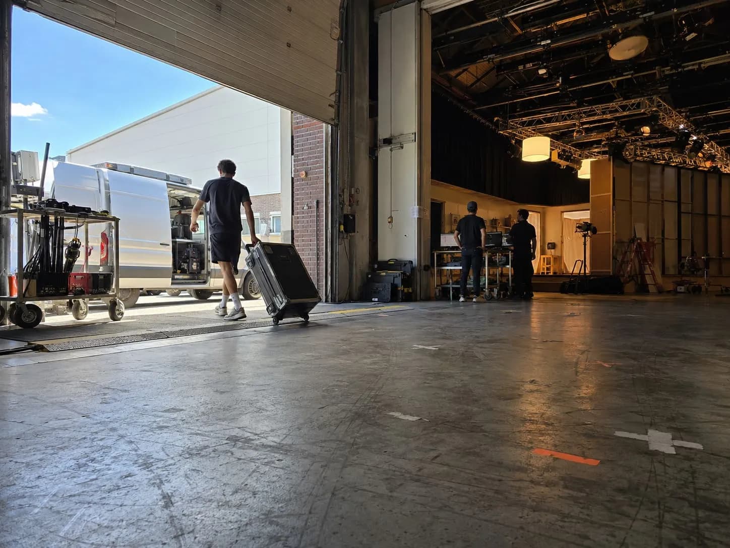 Steel rigging trusses and a chain hoist above a studio stage