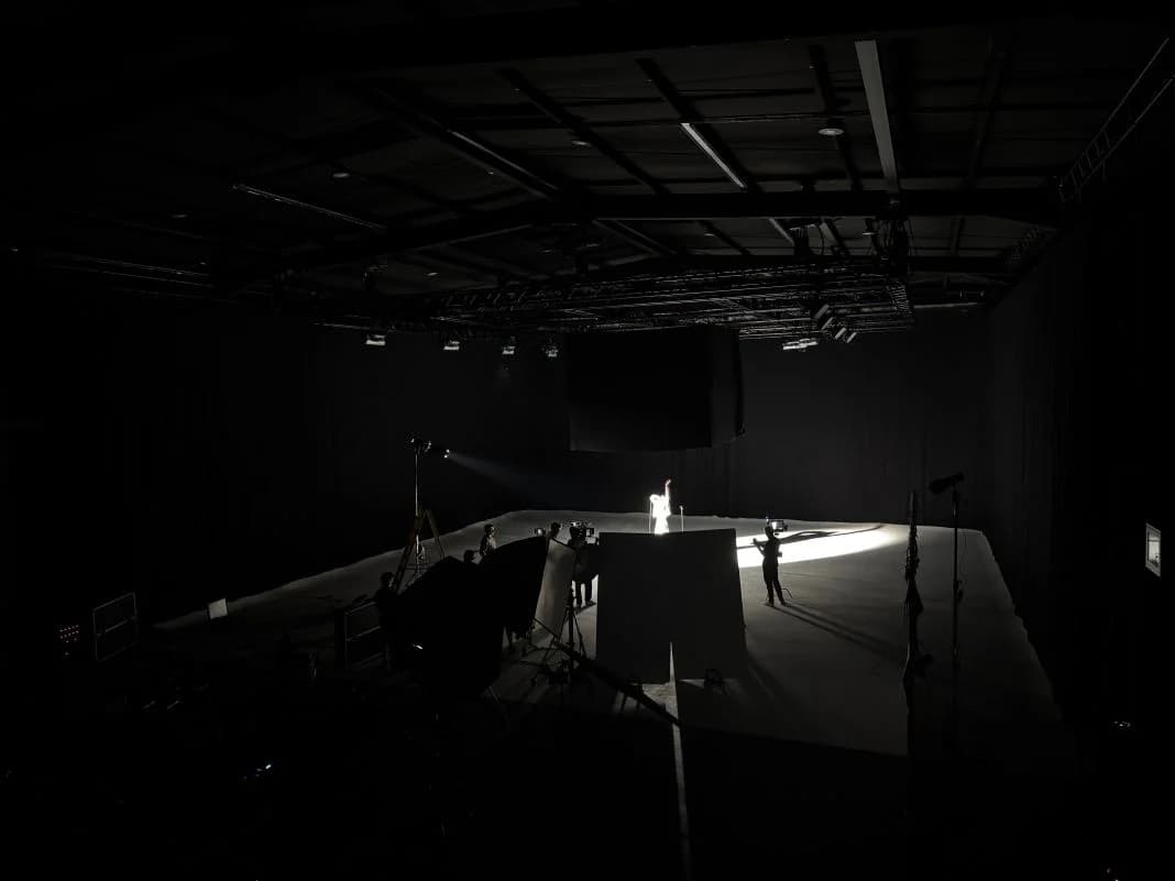 A darkened blackout studio stage with an infinity cove lit low