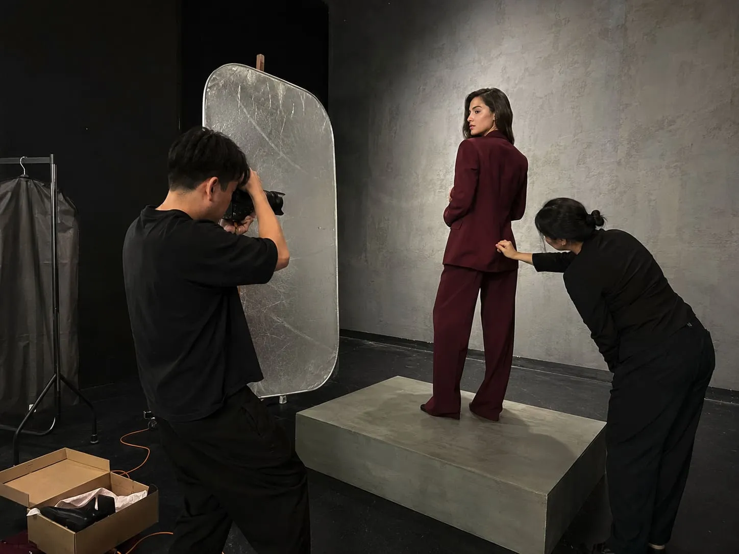 A photo of a women's fashion shoot taking place in a film studio