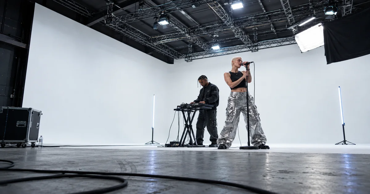 A duet performing music in a film studio