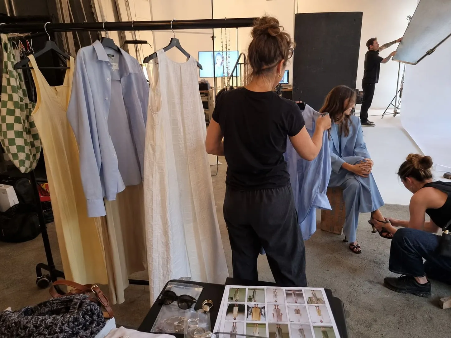 A stylist choosing garments for the fashion shoot