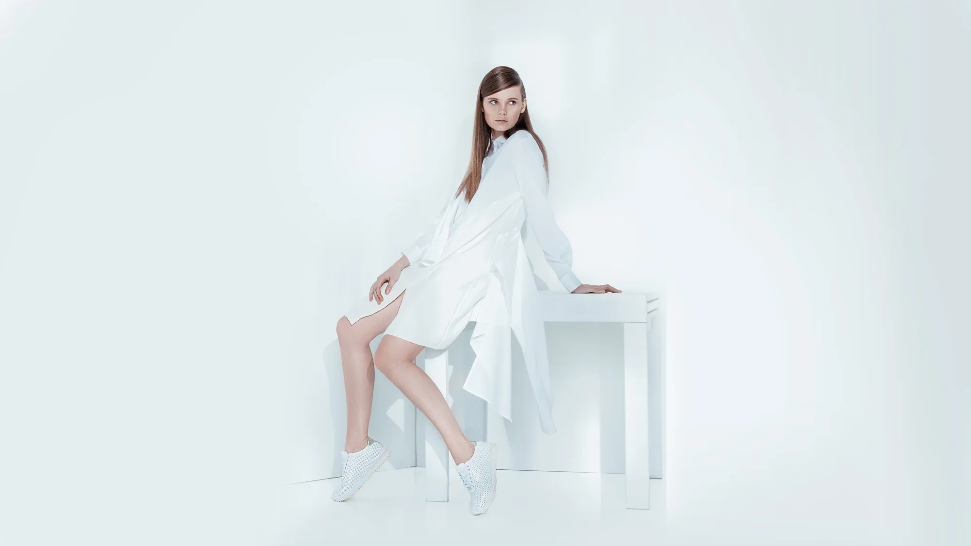 fashion model posing for a fashion campaign in a white cove studio