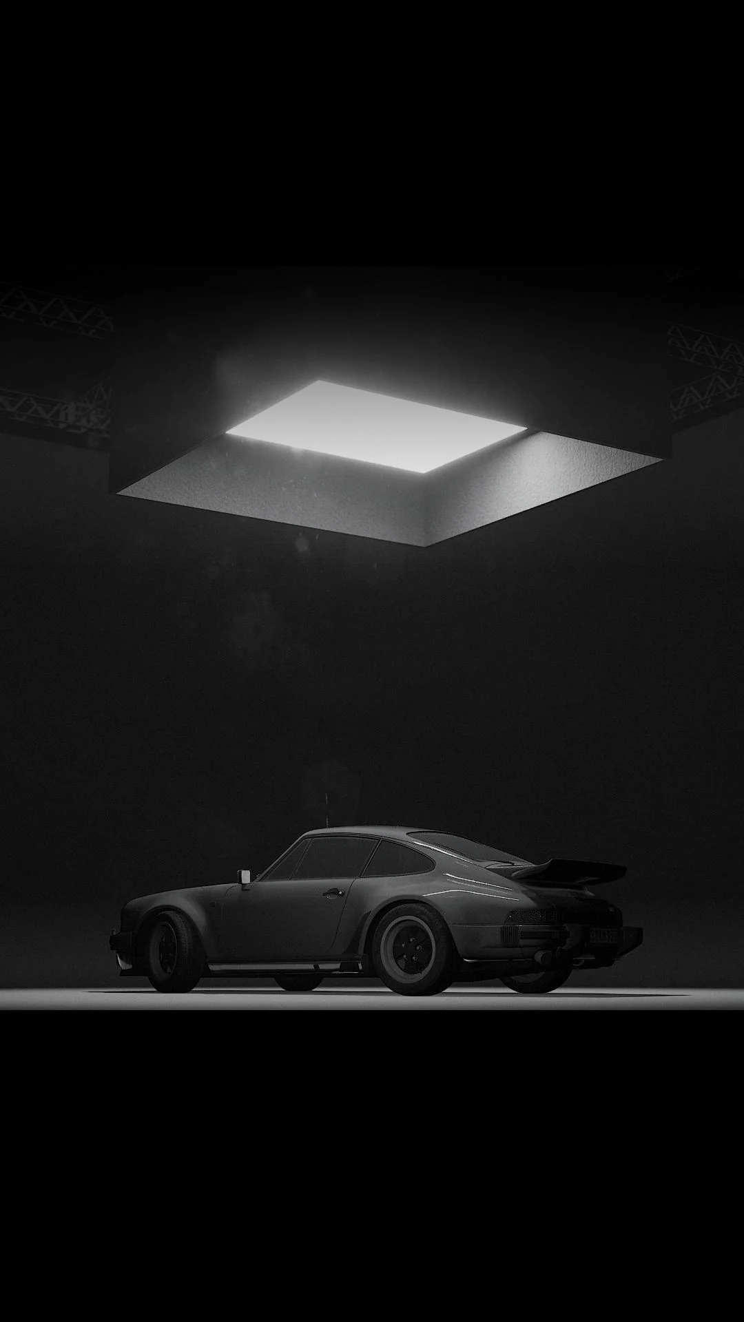 A vintage sports car is parked under a bright square light in a dark room, creating a dramatic atmosphere.