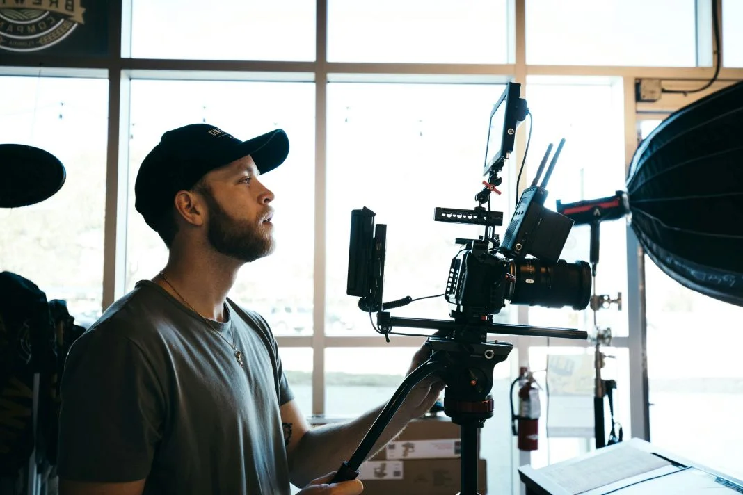 A camera man at a film shoot and new production for a fashion advert