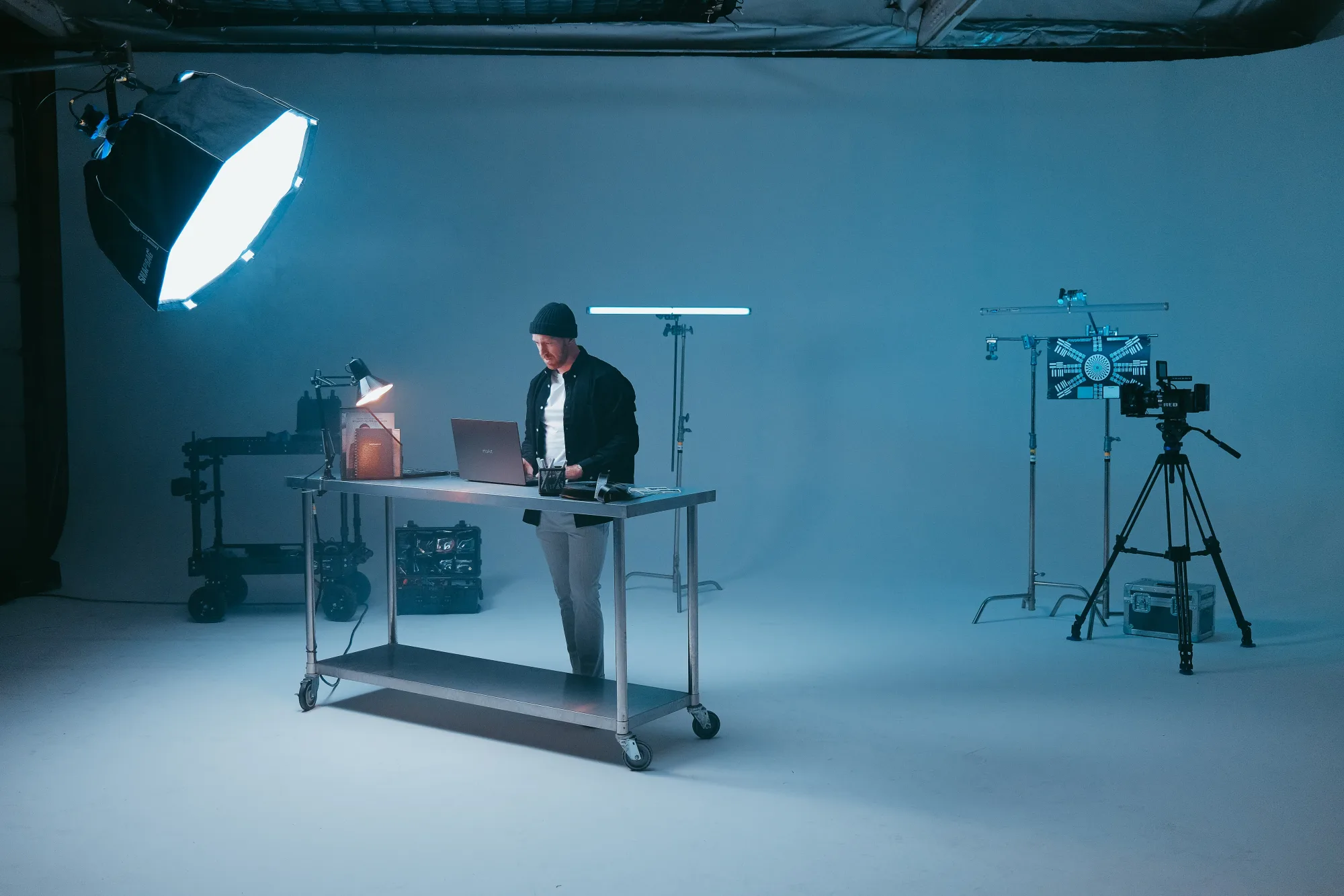 A photo of a film maker being provided equipment in a film studio