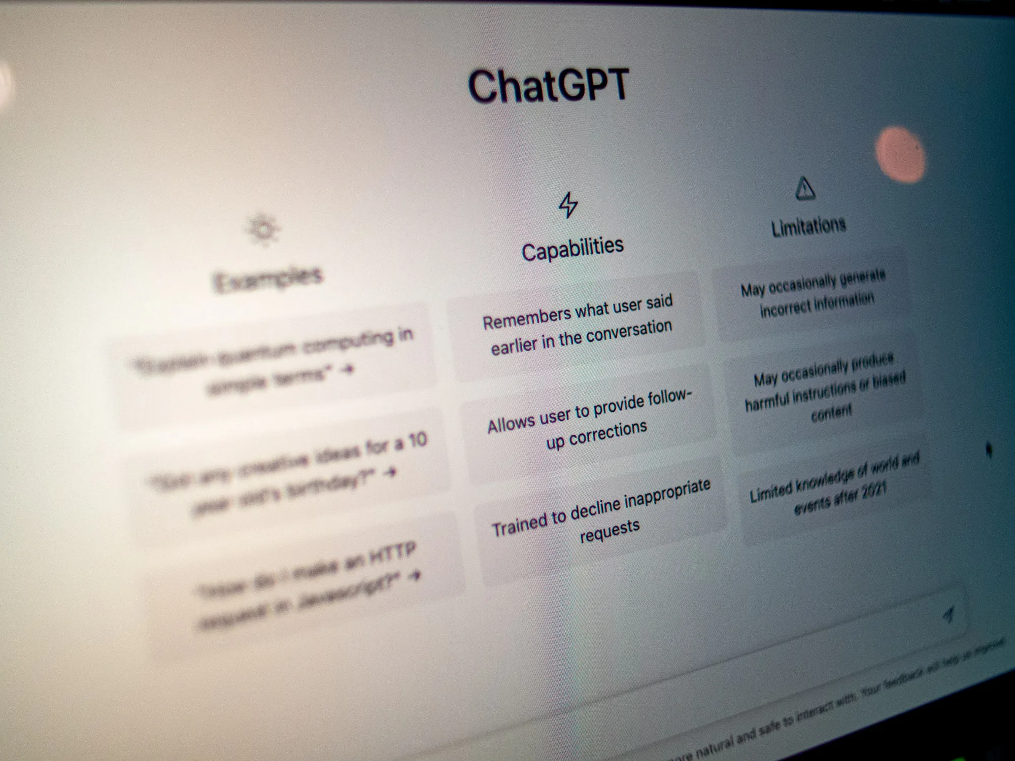 Computer screen displaying ChatGPT interface with sections on examples, capabilities, and limitations. Text is clearly visible.