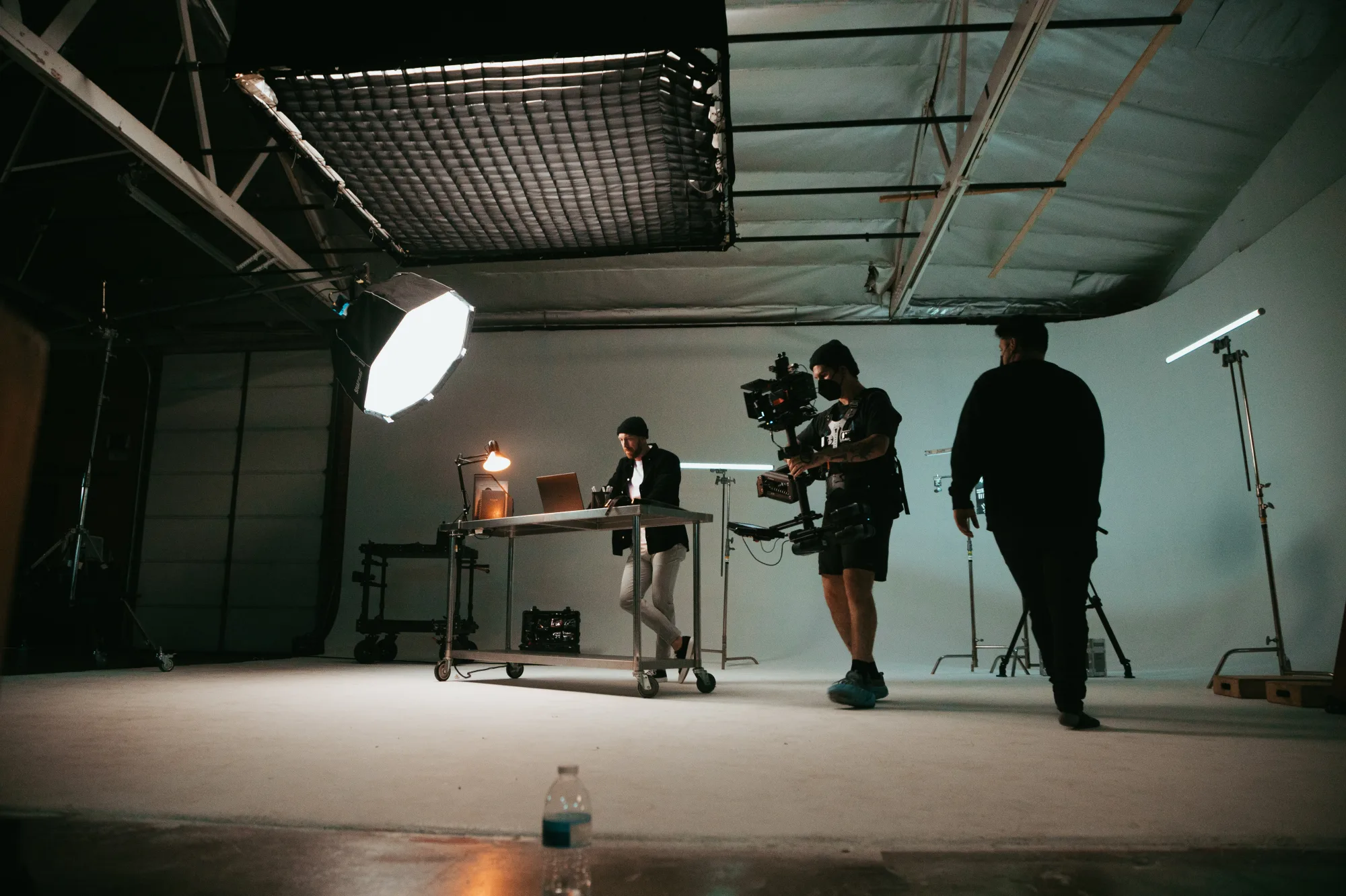 inside of a film studio with people setting up preparing to shoot